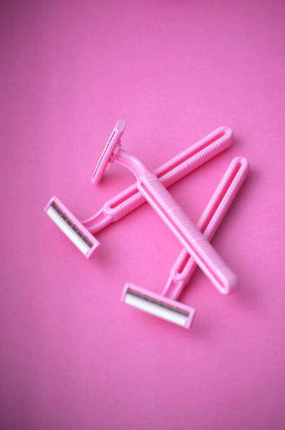 istock Three isolated pink plastic female razors for single use on a same pink background. 1280207164