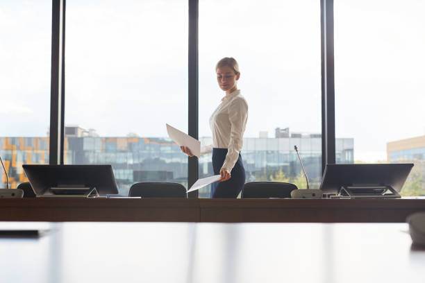 istock Beautiful Business Assistant Laying Out Documents in Conference Room 1280207406