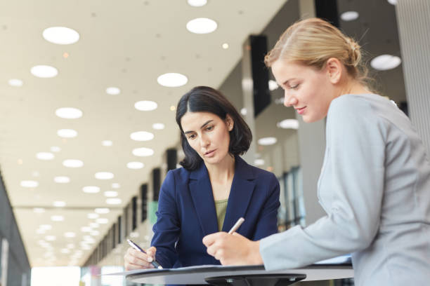 istock Low Angle View at Businesswomen Meeting at Table 1280208021