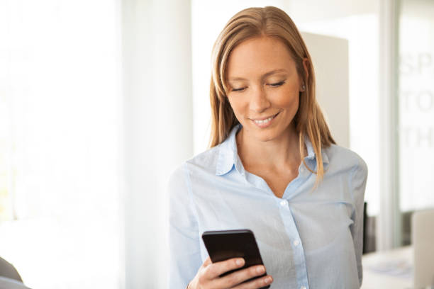 istock Businesswoman using smart phone 1280208555