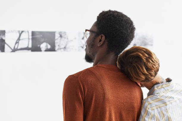 istock Mixed-Race Couple Looking at Modern Art in Museum 1280209507