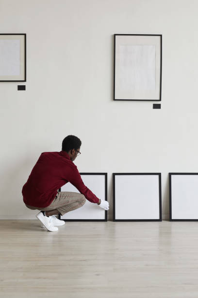 istock African-American Worker Setting Paintings in Museum 1280209518