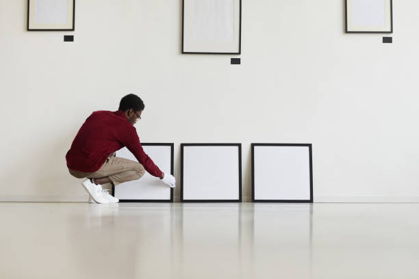 istock African-American Worker Setting Up Paintings in Museum 1280209519