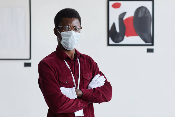 istock African Man Wearing Mask Posing in Modern Art Gallery 1280209609