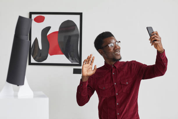istock African-American Man Live Streaming in Modern Art Museum 1280209659