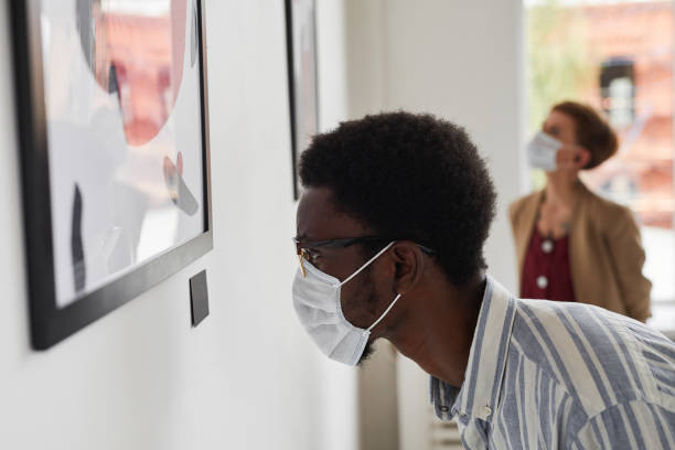 istock Man Wearing Mask Looking at Modern Art in Museum 1280209682