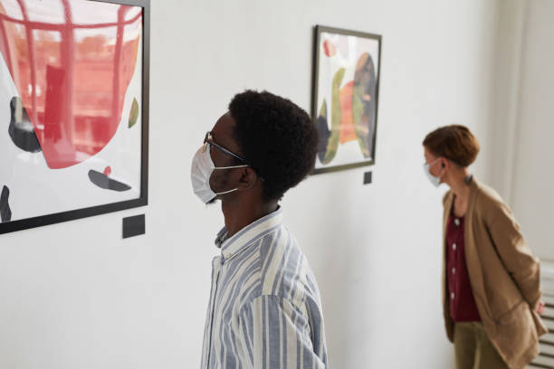 istock People Wearing Masks Looking at Modern Art 1280209690