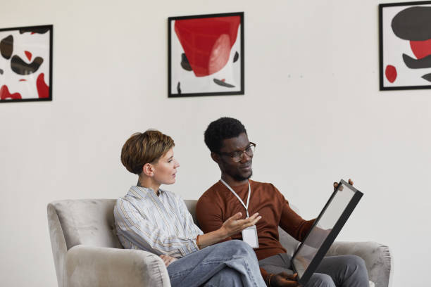 Art Experts Discussing Paintings in Gallery