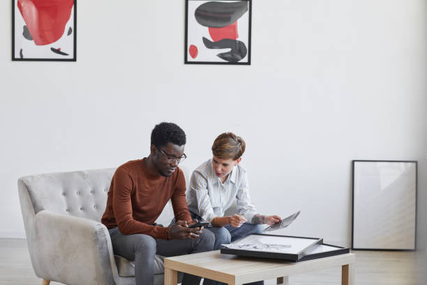 istock Experts Discussing Paintings in Art Gallery 1280209777