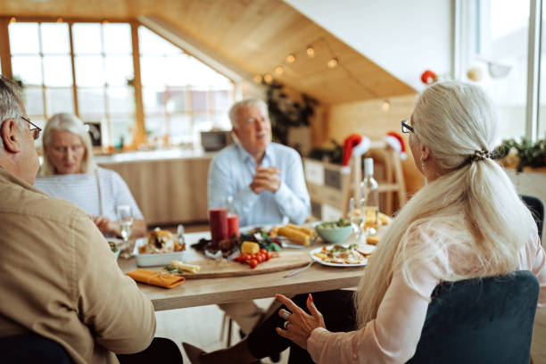 istock Senior friends enjoying lunch during celebration Christmas 1280210690