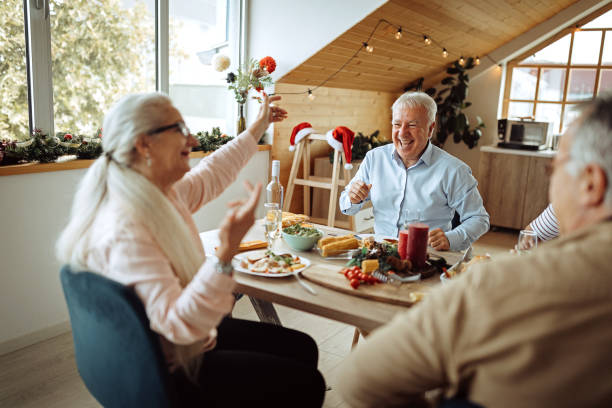 istock Senior friends enjoying lunch during celebration Christmas 1280210715