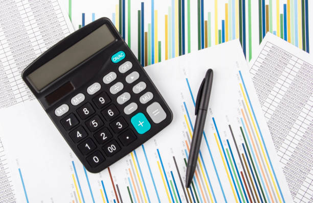 istock Calculator on charts and graphs. Accounting and Financial Analysis concept. 1280210809