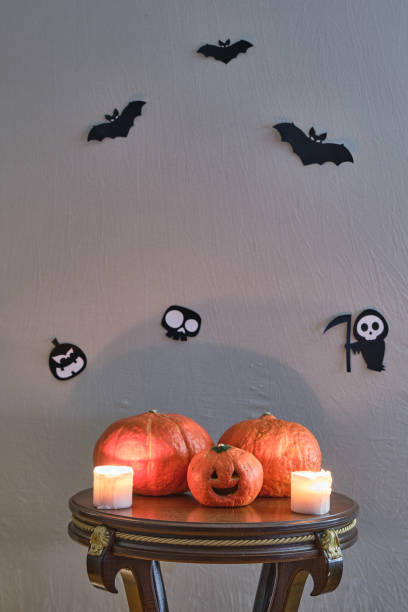 istock Colored pumpkins on wooden stool in front of a black backdrop 1280210925
