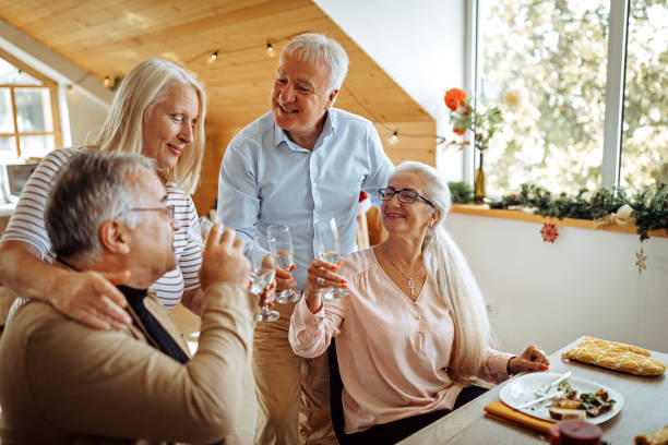 istock Senior couples raising a celebratory toast for celebration Christmas 1280211723