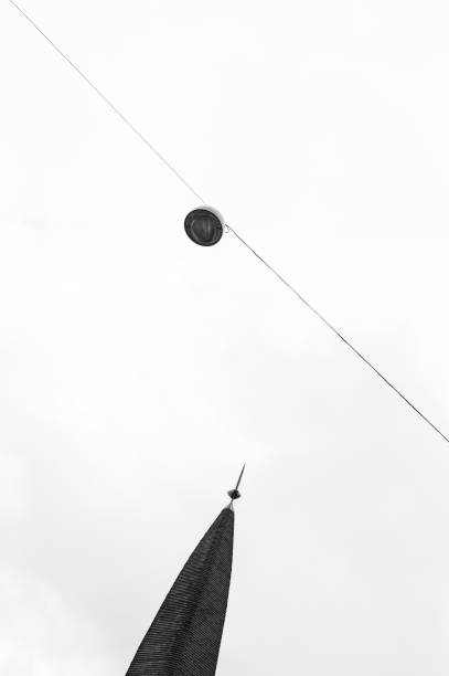 AMSTERDAM, THE NETHERLANDS OCTOBER 07, 2020: High key image of a street lamp and a tower in black and white