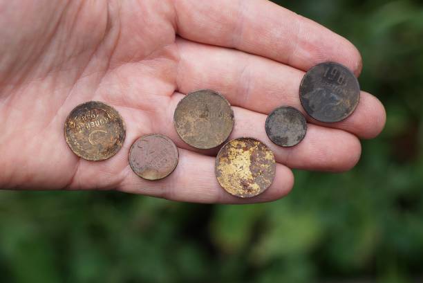 istock many old dirty coins lie on an open palm 1280212430