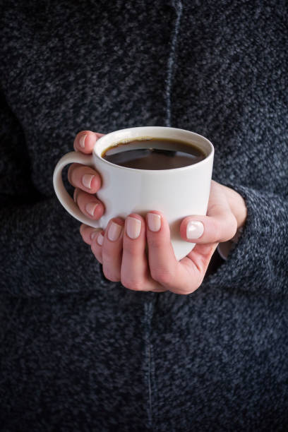 istock holding a cup of coffee 1280213261