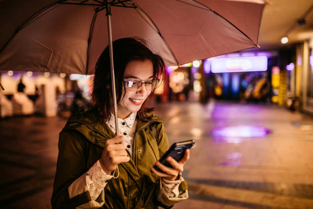 istock Woman checking social media on phone downtown 1280213403
