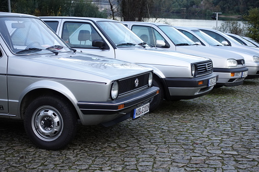 Raiva, Portugal - 11 December, 2019: Volkswagen Golf classic vehicles parked on a public parking. The Golf I (on the first plan) was one of the most popular vehicles in Europe in 70s and 80s.