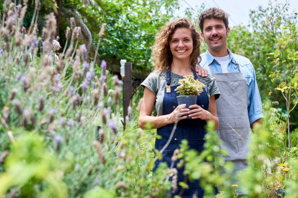 istock Couple standing in plant nursery 1280213754