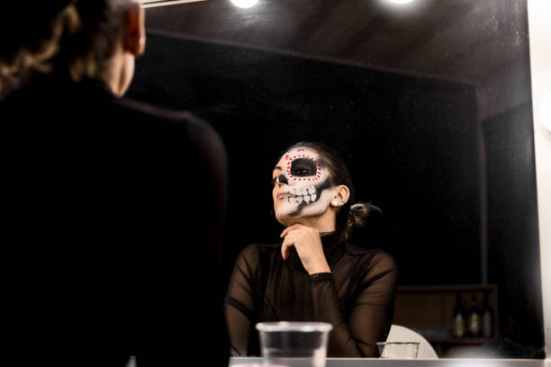 istock Painting face for Halloween night party looking at mirror 1280215901