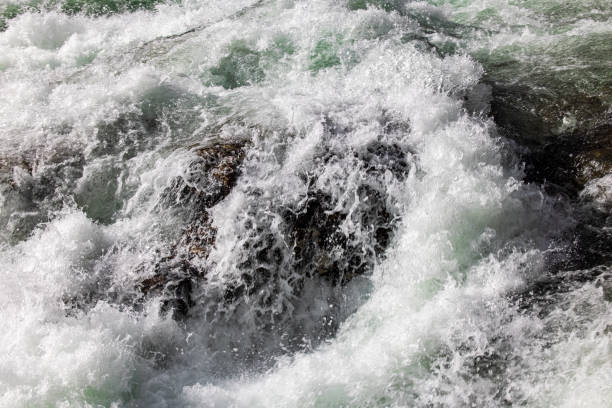 istock Closeup of waves crashing into rock 1280217266