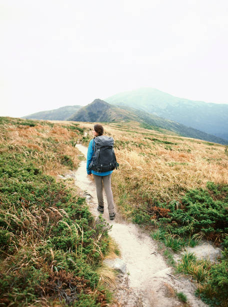 istock Woman hiking in mountains 1280218374