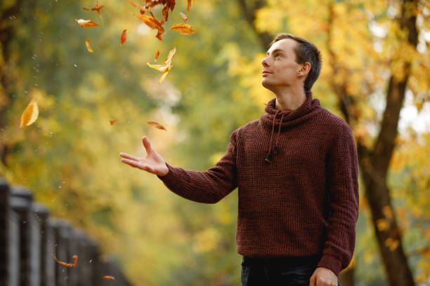 istock Man throw up leaves at the fall day 1280219549