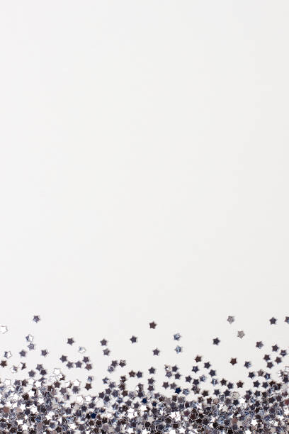 istock Silver confetti on white. Colorful Christmas or holiday background 1280219643