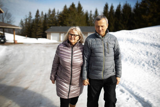 istock Couple Walking Along Snowy Street 1280219722