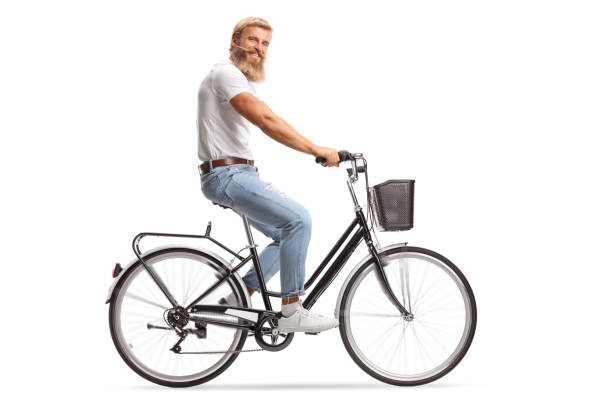 istock Bearded guy with moustaches riding a bicycle and smiling at camera 1280219780