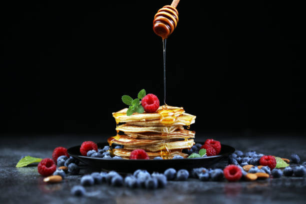 istock Homemade crepes served with fresh raspberrries and powdered sugar on rustic table. 1280220696