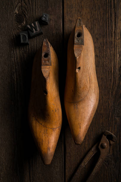 Florence: 04/03/2019 - wooden shape models for making shoes with pincer on a wooden table