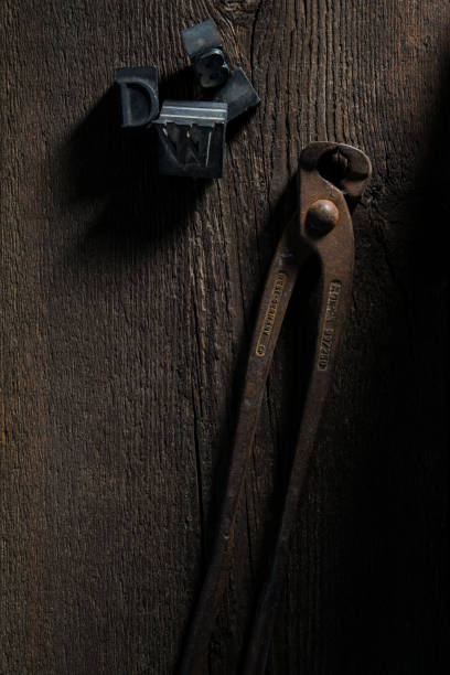 Florence - 04/03/2019: still life of pincer and lead typefaces on a wooden table