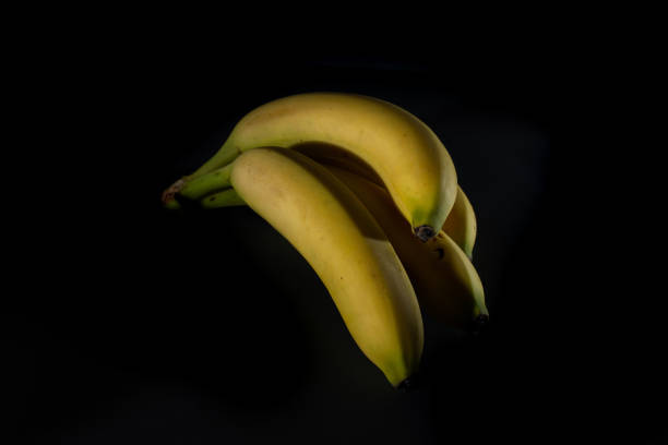 istock Ripe bananas on black background 1280221678