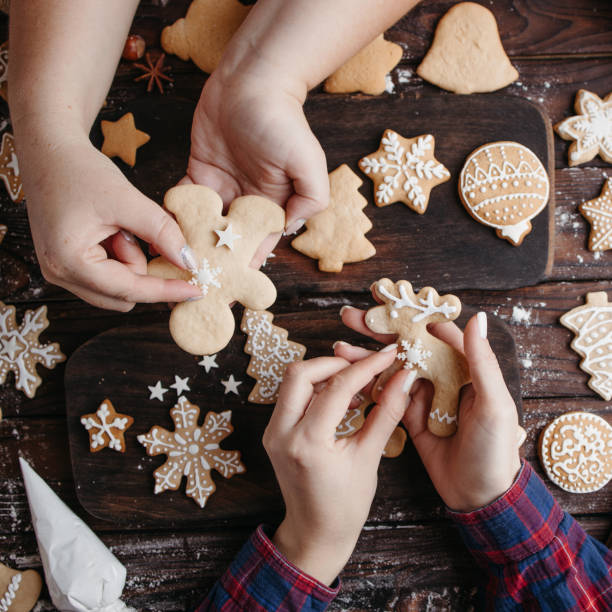istock Family decorating Christmas gingerbread cookies 1280221913