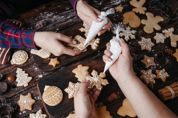 istock Friends decorating Christmas gingerbread cookies 1280221923