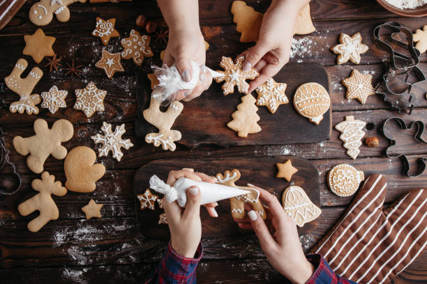 istock Friends decorating Christmas gingerbread cookies 1280221930