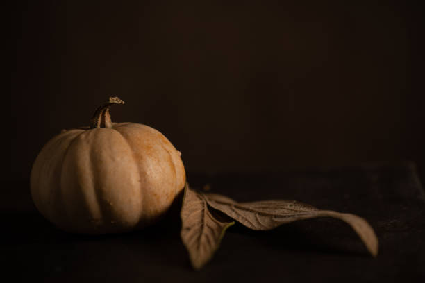 istock Autumn still life with pumpkin and dry leaves 1280224017