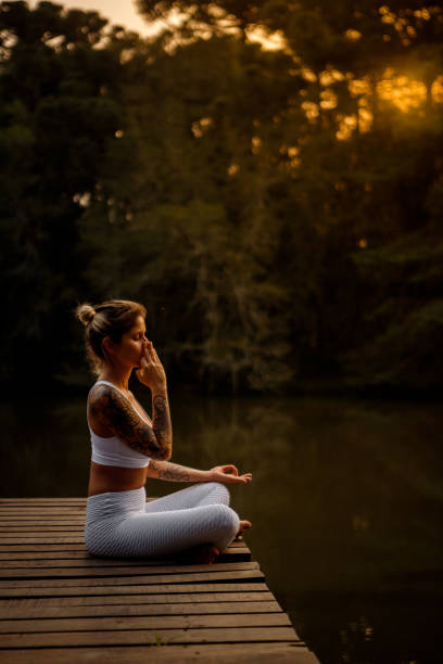 istock woman meditating close to nature 1280224209