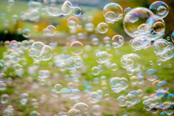 istock Image of soap bubbles on a sunny day on a green meadow. Background. 1280224281