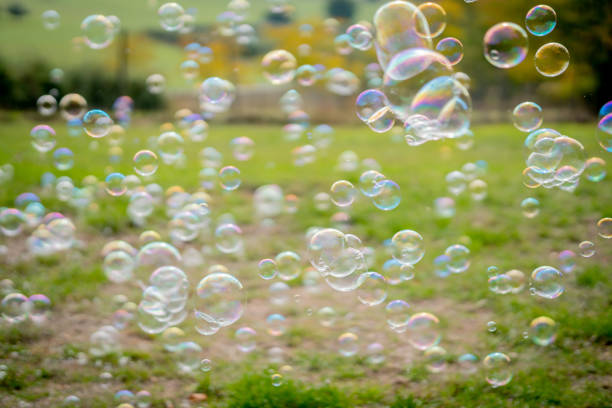 istock Image of soap bubbles on a sunny day on a green meadow. Background. 1280224291