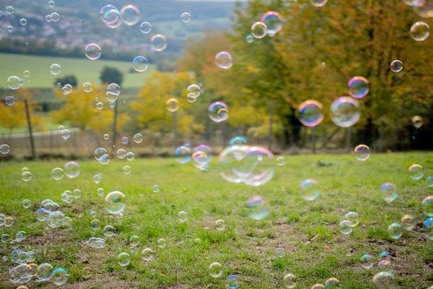 istock Image of soap bubbles on a sunny day on a green meadow. Background. 1280224968