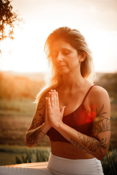 istock woman meditating close to nature 1280225010