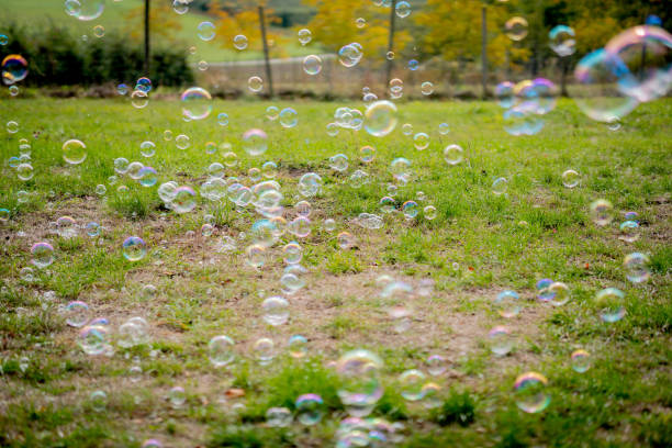 istock Image of soap bubbles on a sunny day on a green meadow. Background. 1280225033