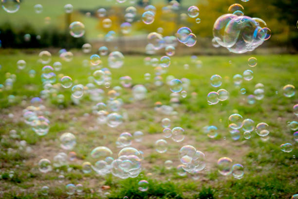 istock Image of soap bubbles on a sunny day on a green meadow. Background. 1280225090