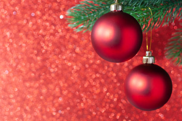 istock two red shiny ball on a new year tree branch on a red blurred background, mock up 1280225136