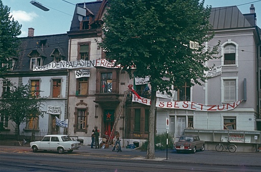 Lower Saxony (exact location unfortunately not known), 1982. House occupied by young people near Hamburg. Also: students, posters, parked cars and the house.