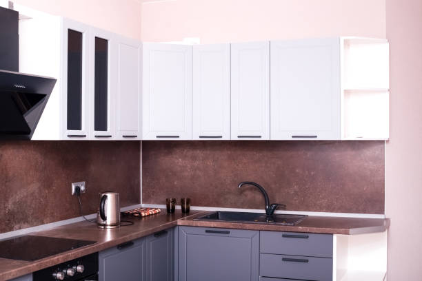 istock Corner kitchen interior with dark brown countertop and backsplash. home furnishings 1280227412
