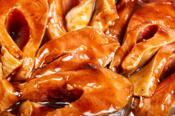 Fish in a marinade of teriyaki sauce before baking